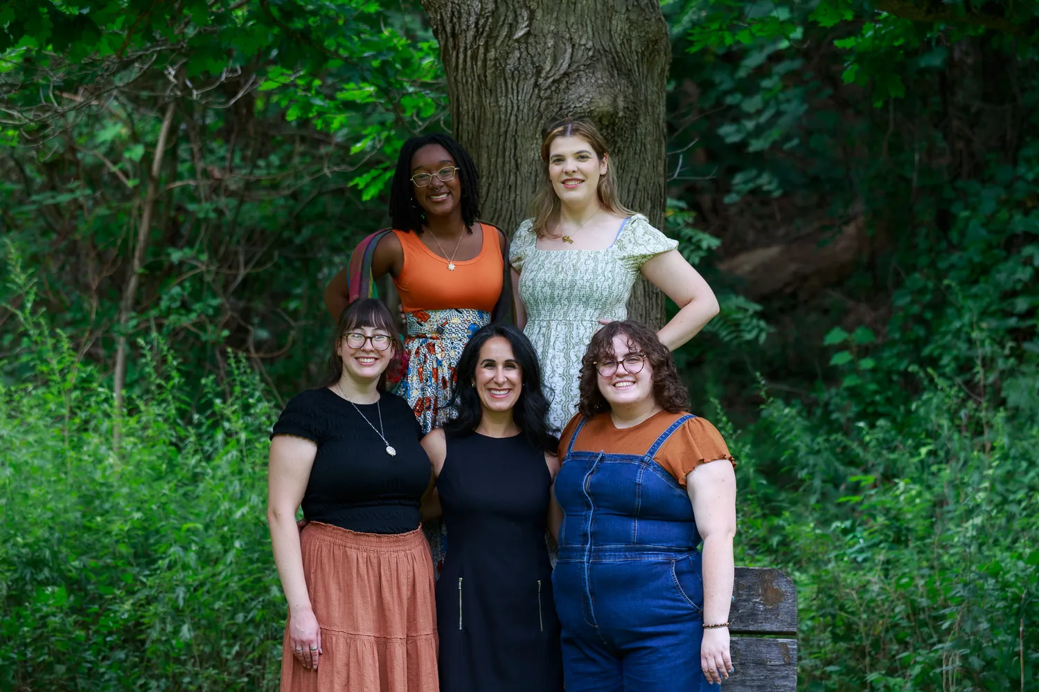 The five members of the Lumera Learning team standing together in front of a large tree, smiling
