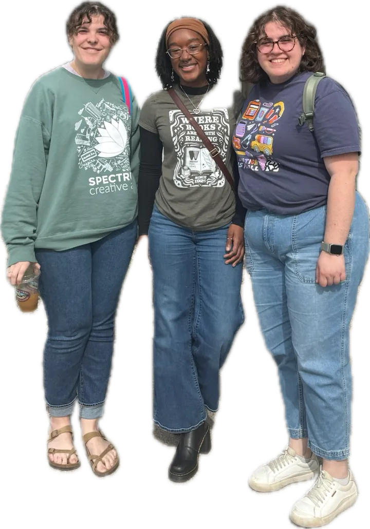 Three members of the Lumera team together, one wearing a Spectrum Creative Arts sweatshirt